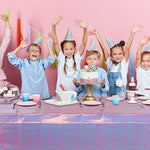 Fully laid out rectangular iridescent purple tablecloth on party table