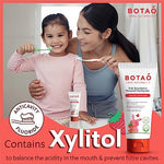 Texture of Botao natural strawberry toothpaste on a child's toothbrush.