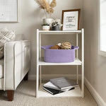 Medium size purple woven storage basket styled as a diaper caddy on a changing table.