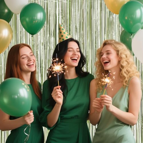 Boho birthday party photo booth setup with shimmering green fringe decorations