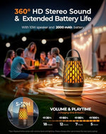 Pair of black cylindrical waterproof wireless speakers illuminating a garden pathway at night.