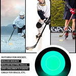 Luminescent green sports training pucks on an asphalt surface