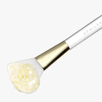 Hygienic face mask application brush for even coverage
