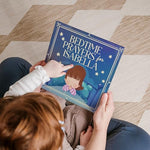 Luna Studios personalized christening keepsake book displayed open to highlight custom dedication text options.