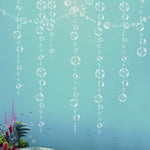 Decor365 under the sea white bubble garlands front view hanging against a dark blue party backdrop