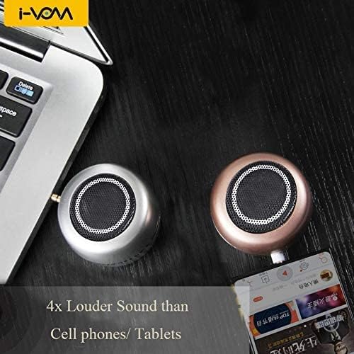 Milcraft mini rechargeable speaker next to a laptop and smartphone setup