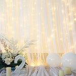 Suppromo ten by eight feet white sheer backdrop curtains styled as an elegant photo booth background
