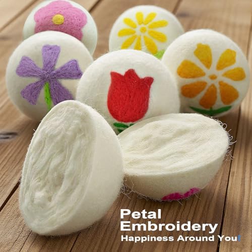 Extra large natural wool fabric softener balls with embroidered flower detail next to storage pouch