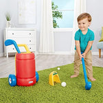Toddler playing with Little Tikes golf clubs and balls