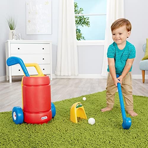 Toddler playing with Little Tikes golf clubs and balls