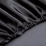 Twin size bed styled with Homiest black satin fitted sheet