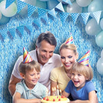 Close up view of the thick shiny curved edge tinsel on the blue party curtain