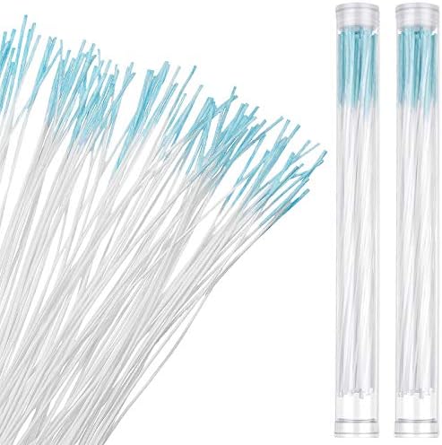 Close-up of a hand extracting a thin disposable ear piercing cleaner floss thread from the clear plastic tube.