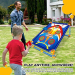 Children playing with rocket bean bag toss set in backyard