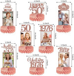Pink and rose gold fiftieth birthday photo table toppers arranged on a party table set