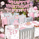 Table setting with pink bow tablecloth and tableware