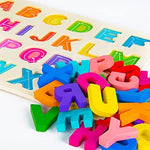 Attmu educational ABC learning toy with individual wooden letters standing upright on a flat surface.