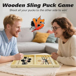 Bakam wooden slingshot board game for two players during active gameplay