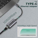 QGeeM portable USB-C network dongle placed alongside its complimentary travel pouch.
