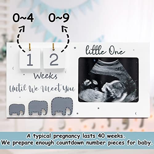 Jwitao sonography picture frame styled as nursery decor on a wooden shelf.