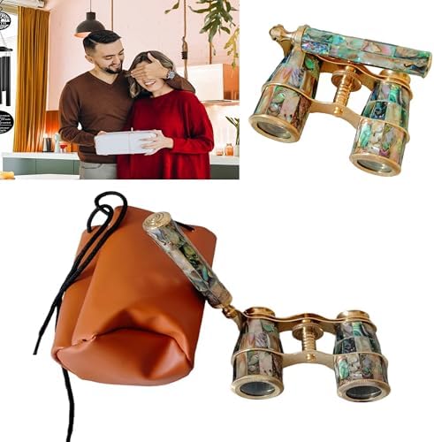 Compact three times magnification opera binoculars held in hand to demonstrate lightweight portable size