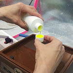 Purple water soluble grinding fluid by Novacan for extending diamond bit life in hobby studios.