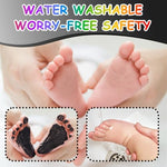 Completed black baby handprint and footprint memento on white cardstock.