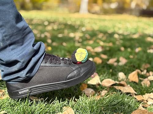Synthetic suede sand filled footbag in green yellow and red color panels