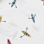 Close up of multi-colored kayak pattern on white cotton fabric