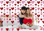 Romantic home setup featuring red and pink heart garlands across a doorway