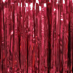 Close up view of the fade resistant metallic red tinsel streamers highlighting the shimmering reflective quality under party lights.