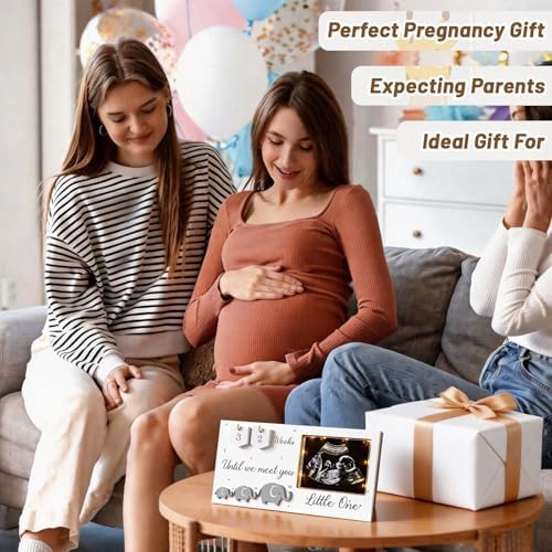 Lewtemi baby countdown weeks sonogram frame lit up in a dark room showing the soft eye protective ambient glow
