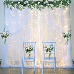 Suppromo sheer net curtain background setup for birthday party decorations with hanging LED light strings