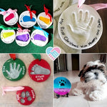 Finished baby handprint clay plaques displayed elegantly on two included wooden tabletop easels