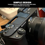 Aisnyho ergonomic camera thumb rest hand grip mounted on a mirrorless camera hot shoe.