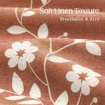 Close-up of the botanical wildflower pattern and white wheat print on the rust-colored fabric.