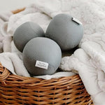 Set of three gray reusable vegan dryer balls made from recycled plastic.