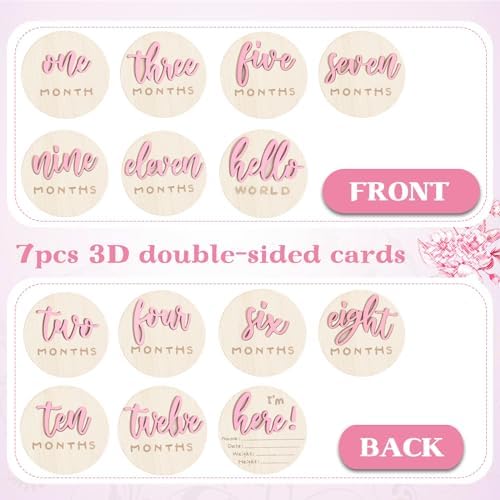 Burbell monthly growth tracking wooden discs next to a pink baby blanket background