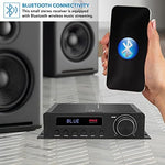 Pyle mini power stereo amplifier receiver system placed inside a home entertainment center