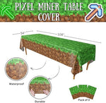 Disposable pixelated gaming party tablecloth spread across a rectangular table as a vibrant birthday decoration.