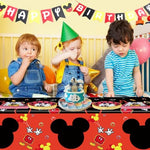 Kids first birthday celebration setup featuring premium black and red table spreads