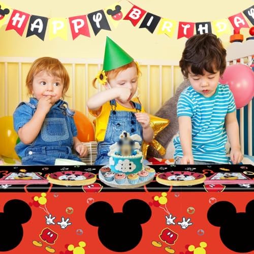 Kids first birthday celebration setup featuring premium black and red table spreads