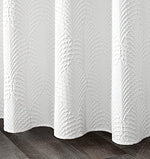 Gibelle luxury hotel style white curtain installed on a rod with the included twelve durable hanging hooks.