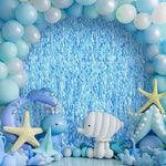 Under the sea themed birthday party setup using blue wavy fringe streamers