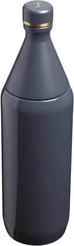 Slim travel water bottle from Stanley placed inside a car cup holder.