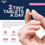 Tiny easy to swallow Freeda prenatal tablets on a surface