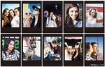 Glossy credit-card-sized developed instant photos with distinct solid black frames lying flat