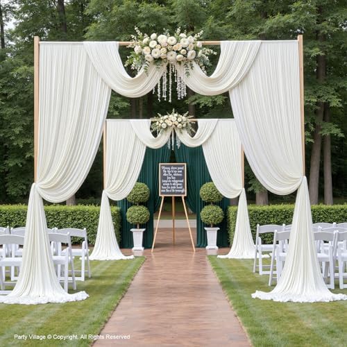 Party Village cream color photography backdrop drapes styled with wedding floral arrangements