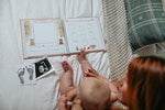Side profile of the gender neutral Lucy Darling baby memory book demonstrating the sturdy hardcover linen binding.