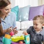 Toddler adjusting the elephant trunk on the teal Playskool active toy for continuous ball cycling.